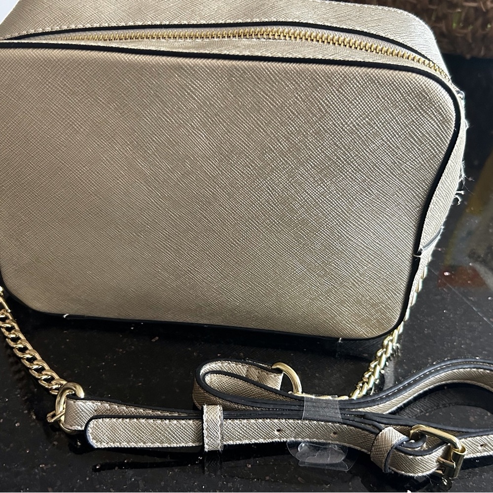 Brand new, with tags metallic handbag with zippers and adjustable strap